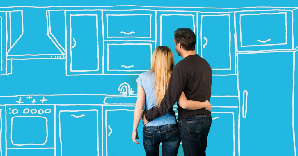 Happy embracing couple planning their home kitchen furnishing renovation. Sketch kitchen drawing.