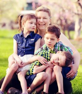 Lisa Potapoff with her three children.They are smiling as they are settling into our new home.